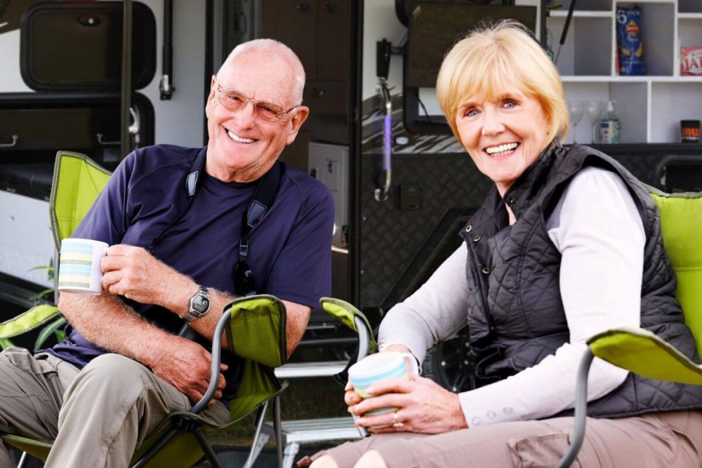 Grey nomads enjoy relaxing with their pop top off road caravan